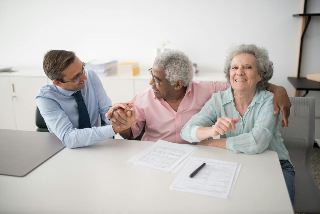 A senior couple discussing their insurance needs with a professional. — insurance tips for seniors Nevada