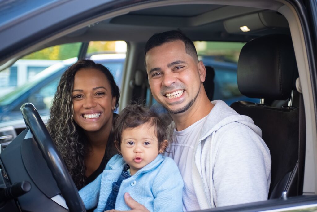 An image of a happy family driving a car, symbolizing safe driving. — Nevada car insurance discounts