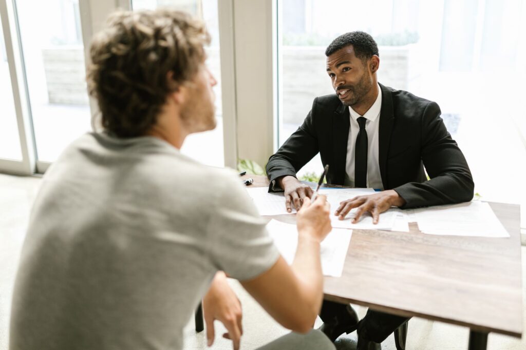 An image of a veteran discussing insurance with an agent. — military car insurance nevada