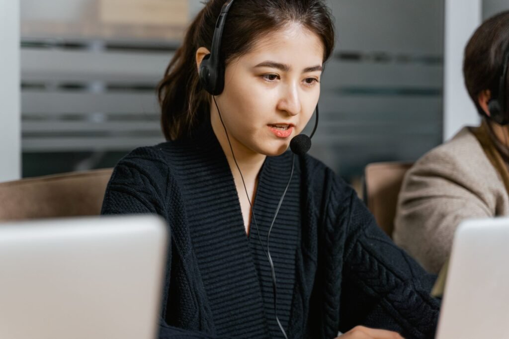 A customer service representative assisting a client online while they explore options to buy car insurance online Nevada