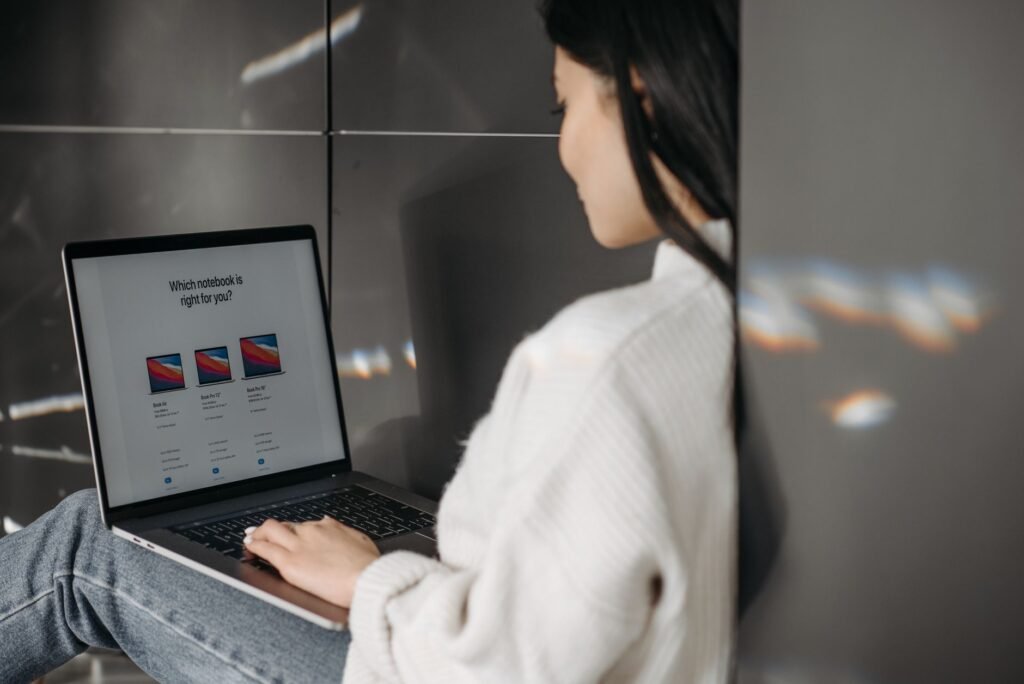 A person comparing car insurance quotes on a laptop, representing research and comparison. — mistakes buying car insuran…