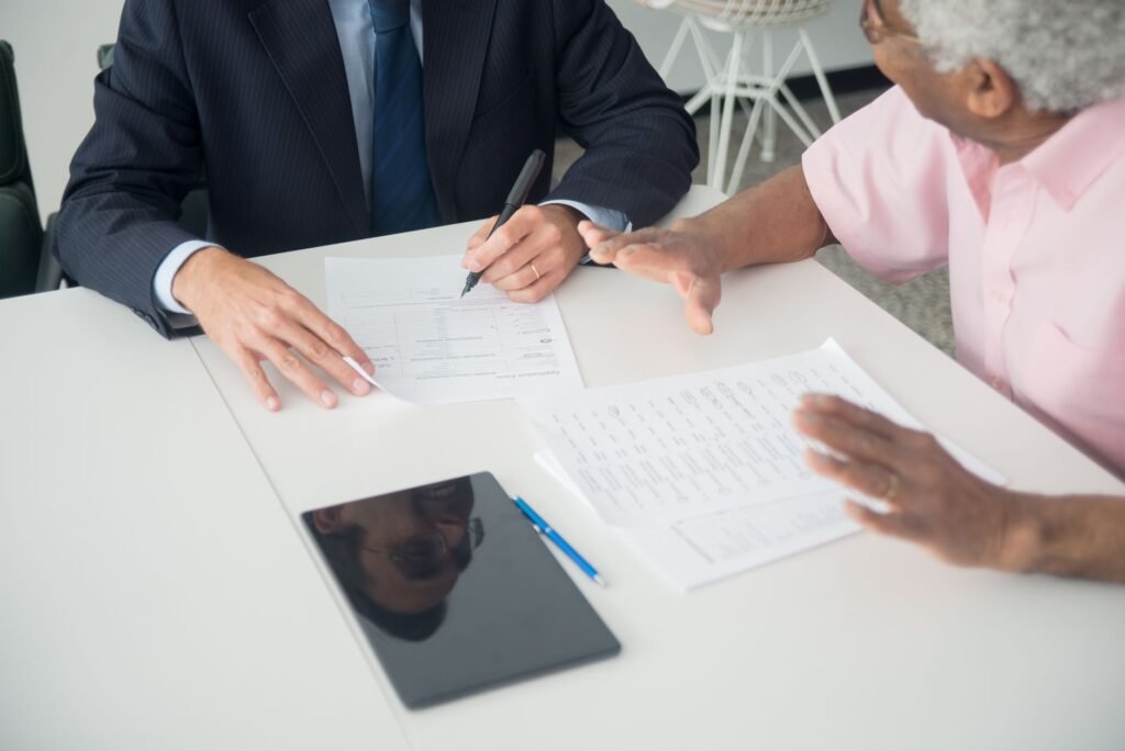 A photo of a consultation between a car owner and an insurance agent discussing full coverage vs liability insurance in Ne…