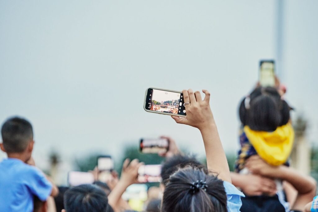 A photo of a person documenting an accident scene with a smartphone — file car insurance claim Nevada