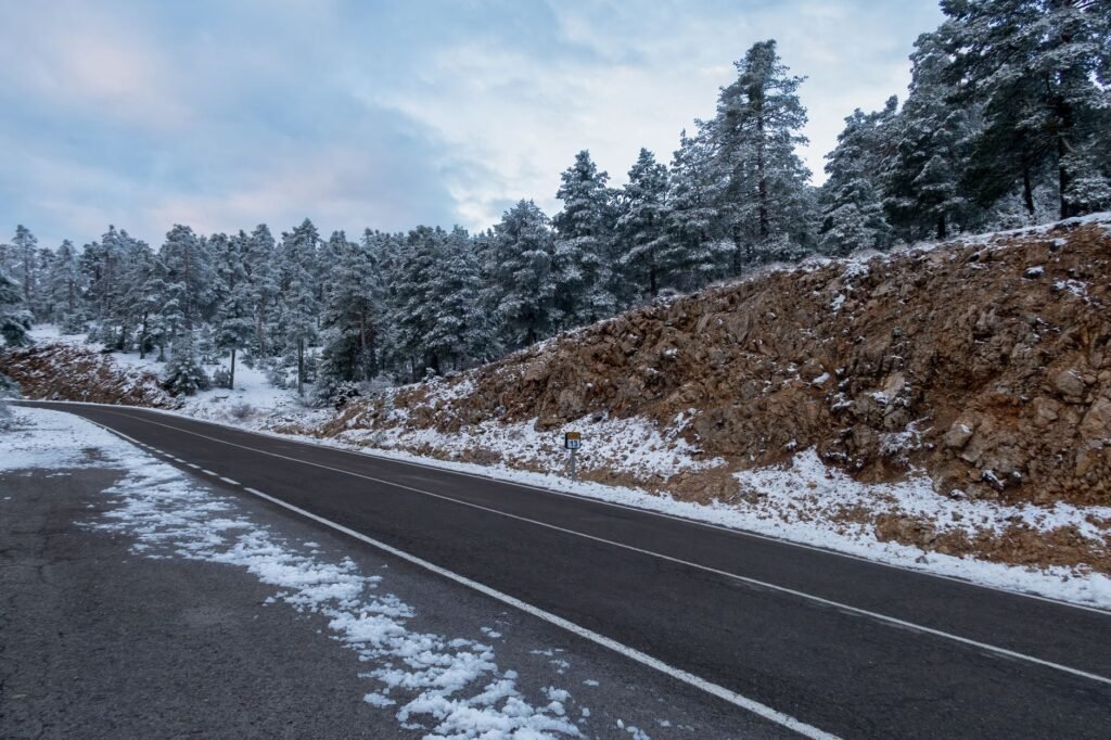A photo of a rural road in Nevada during winter, illustrating the seasonal driving challenges related to Nevada driving conditions insurance rates.