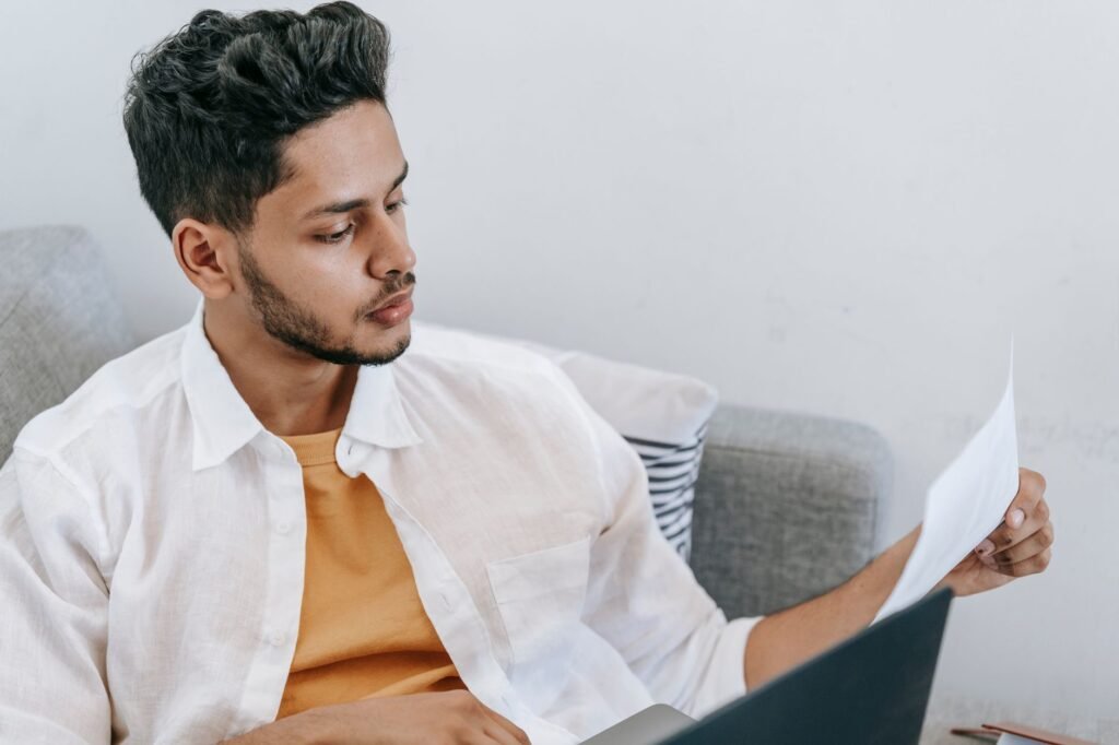 A photo of a young driver reviewing insurance quotes on a laptop. — car insurance for young drivers Nevada