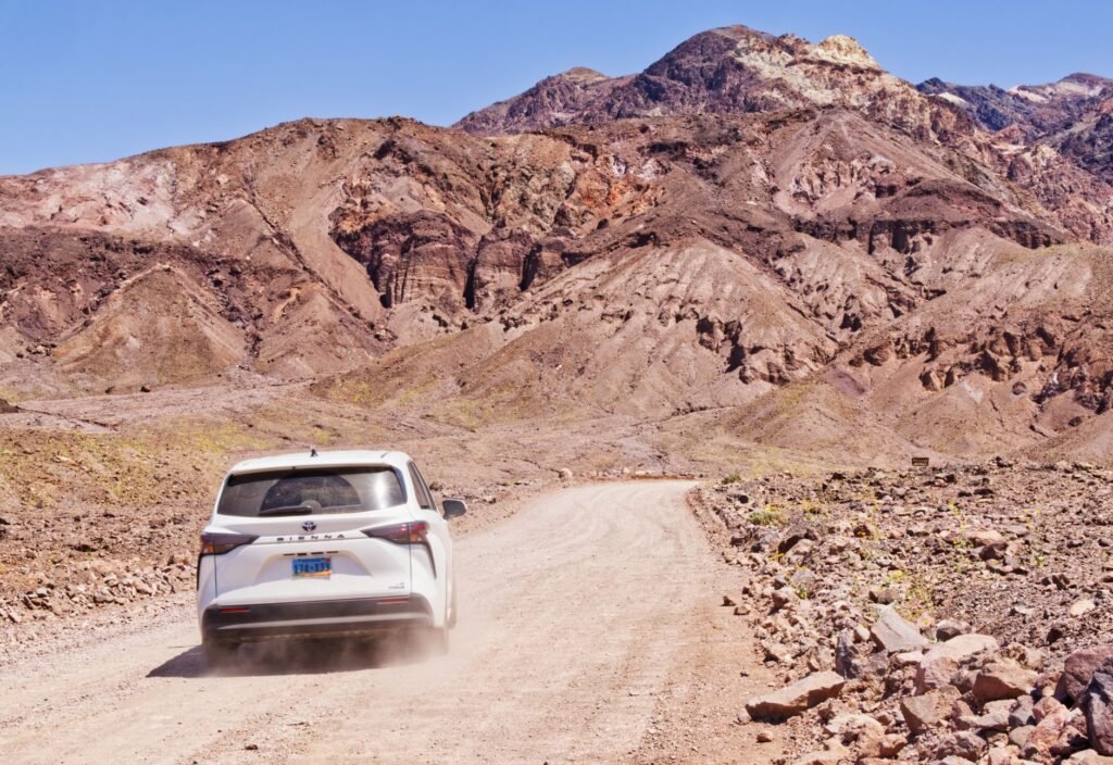 An image of a car navigating a desert road, representing the unique driving conditions in the state. — Nevada driving co…