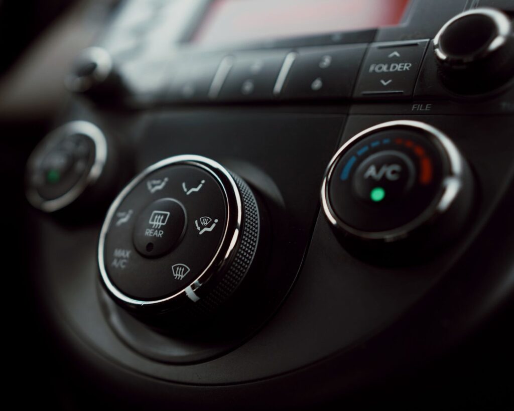Close-up of a car dashboard showing high temperature readings to represent desert driving conditions. — Nevada driving c…