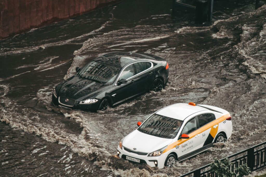 Photo of a vehicle navigating through a flash flood in Nevada to highlight weather risks. — Nevada driving conditions in…