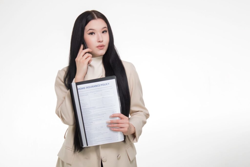 An image showing a person on the phone, following up on their insurance claim to file car insurance claim Nevada