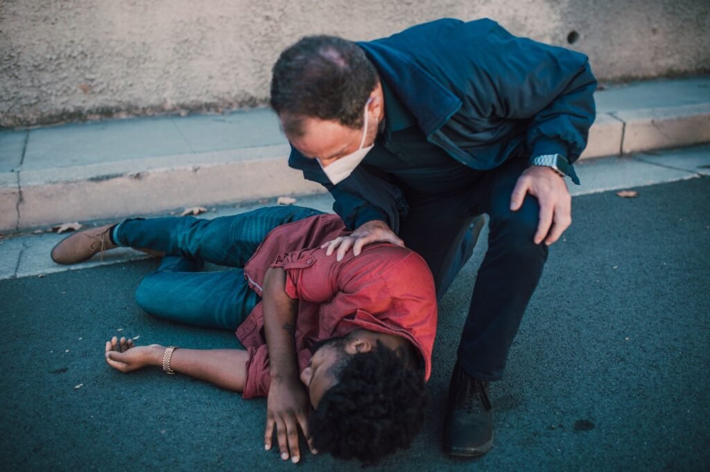 A driver checking for injuries after a car accident. — after car accident Nevada insurance