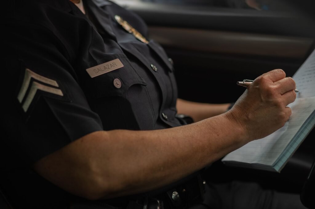 A police officer taking statements at an accident scene. — after car accident Nevada insurance