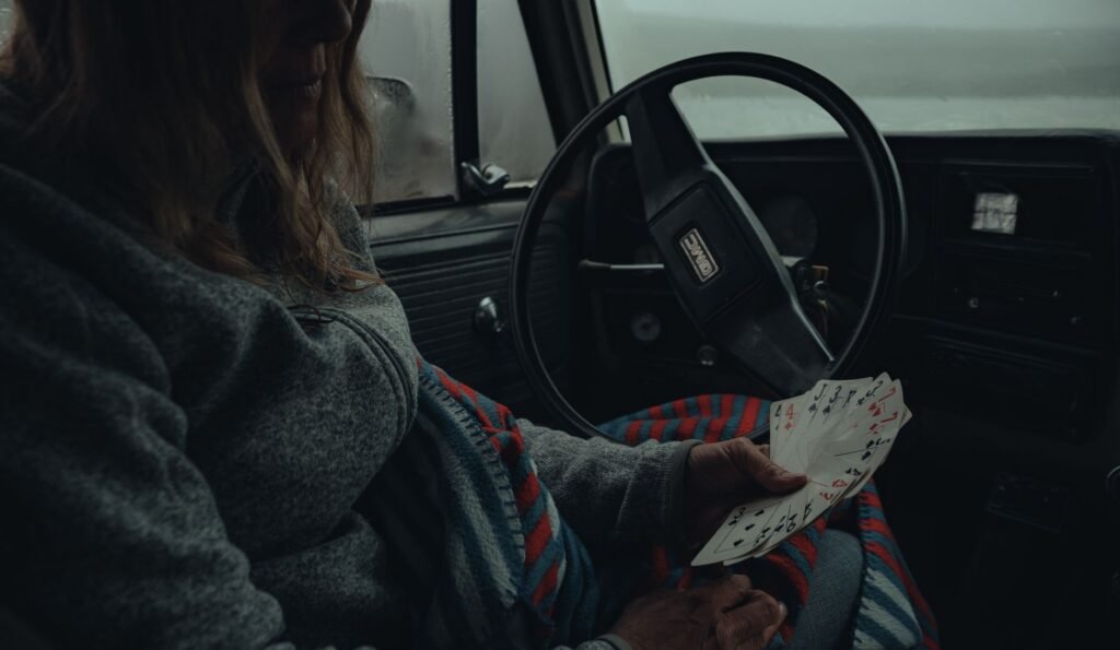 An image of a Nevada driver holding their insurance card. — Nevada car insurance requirements