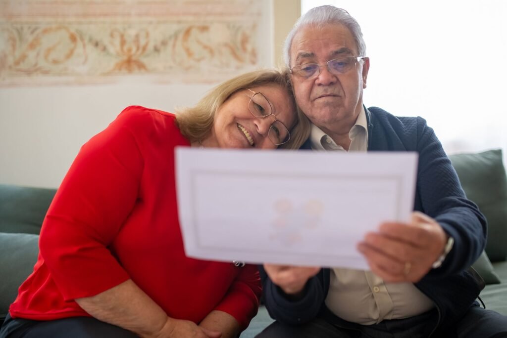 An image of a happy couple with their bundled insurance documents. — bundling insurance Nevada