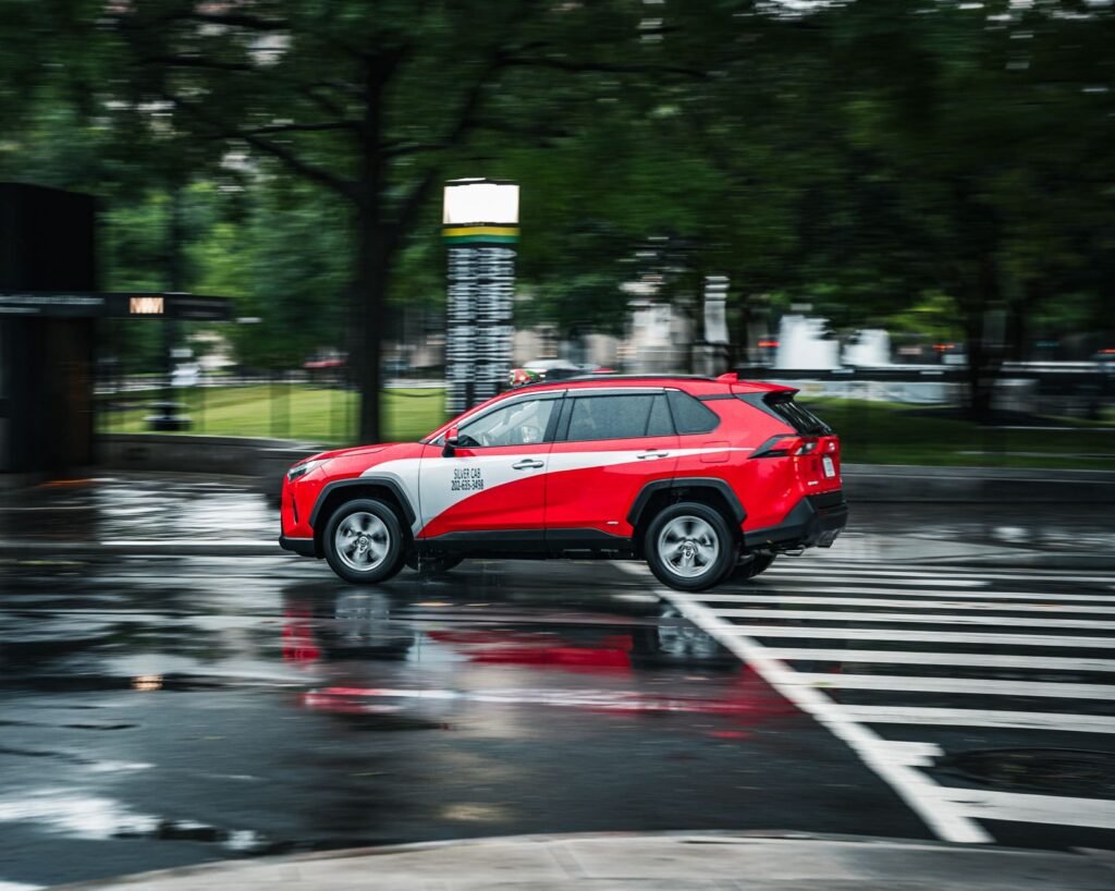 An image of a red car with a caption debunking the color myth in insurance. — Nevada car insurance myths