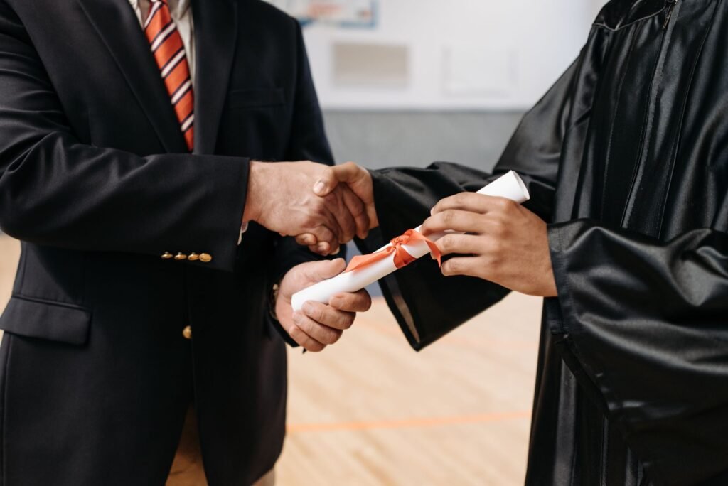 An image of a student receiving a good grades award related to car insurance discounts — Nevada car insurance discounts