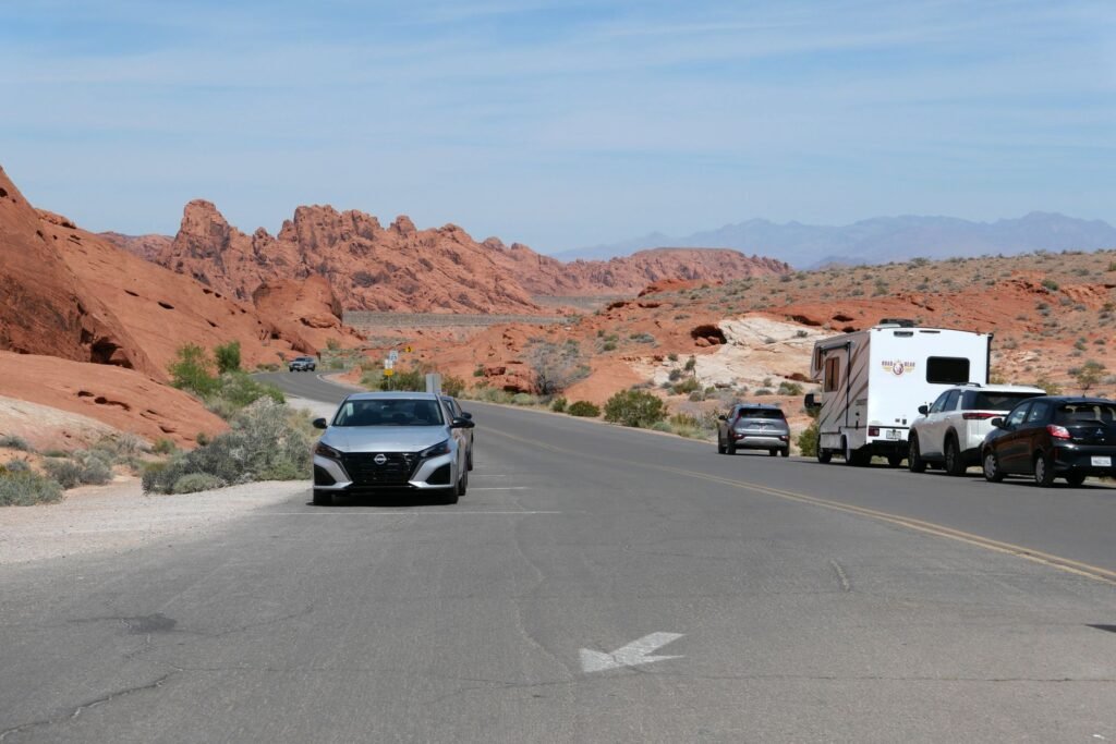 Image of a Nevada highway sign with a car in the foreground. — Nevada car insurance requirements